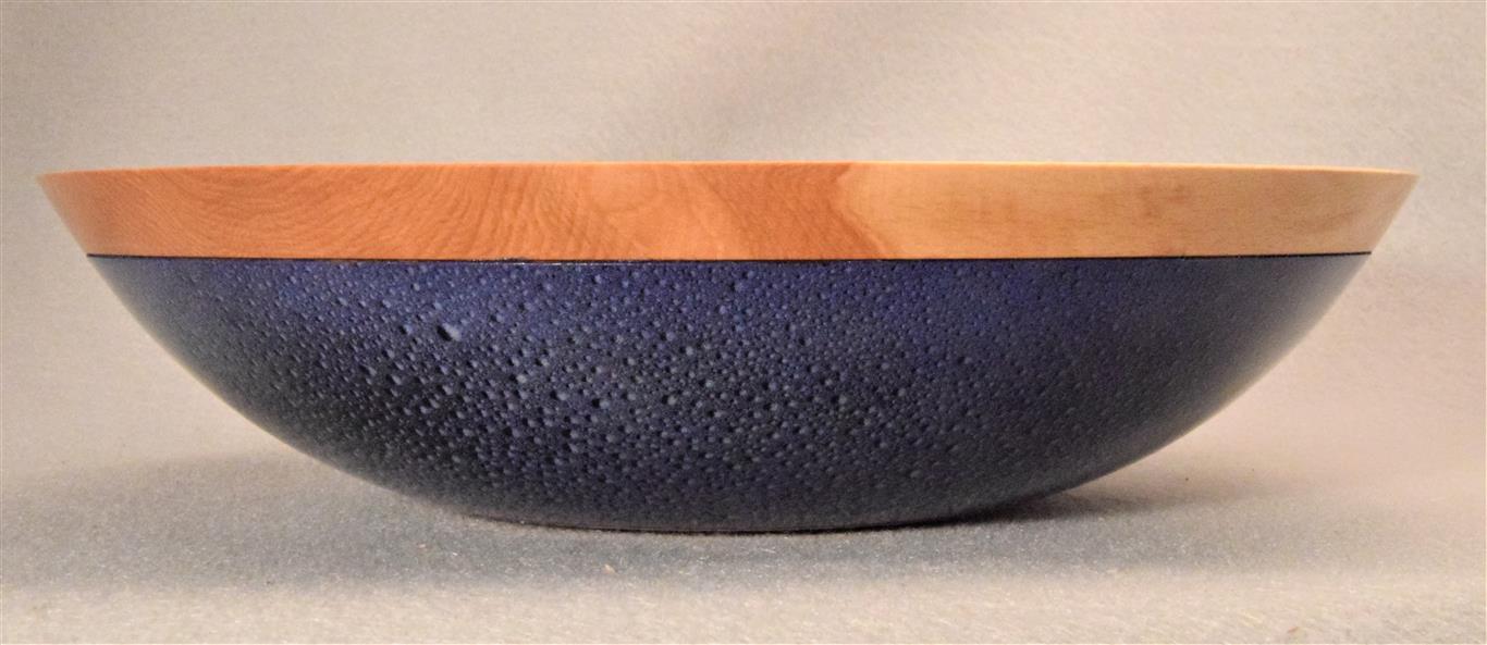 Beech Bowl with 3D Raindrop Pattern: On a blue background